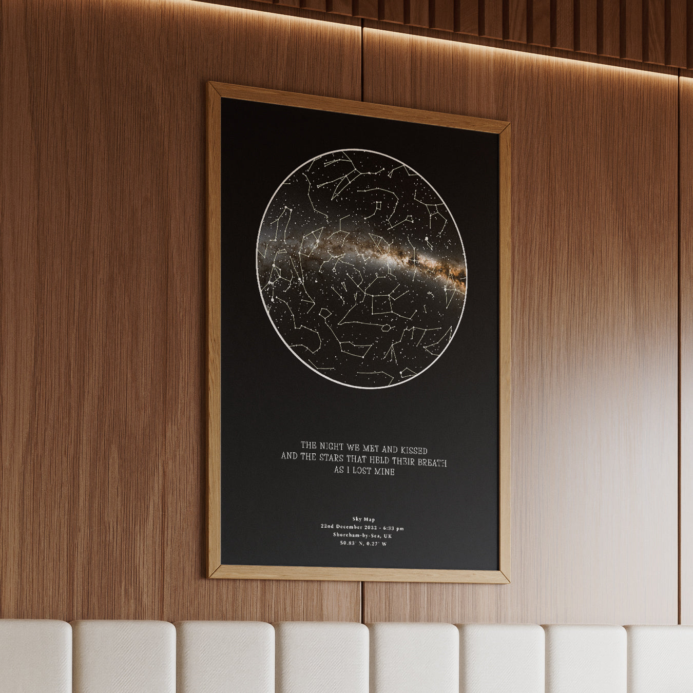 Personalized framed star map print in a natural wood brown frame, featuring a deep black night sky design with constellations and the romantic quote &