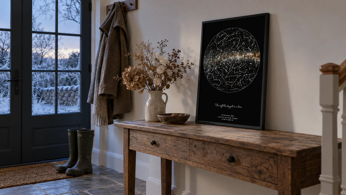 A personalised star map print of the night sky leaning on a hallway console table at frosty winter dawn
