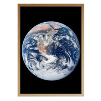 The Blue Marble print in a natural brown wood frame