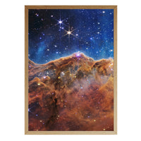 Cosmic Cliffs print in a natural brown wood frame