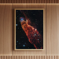 Elegant framed space print of Herbig-Haro 49/50 nebula in deep crimson and amber tones, perfect for adding a cosmic touch to modern interiors – by Skylit Studio.