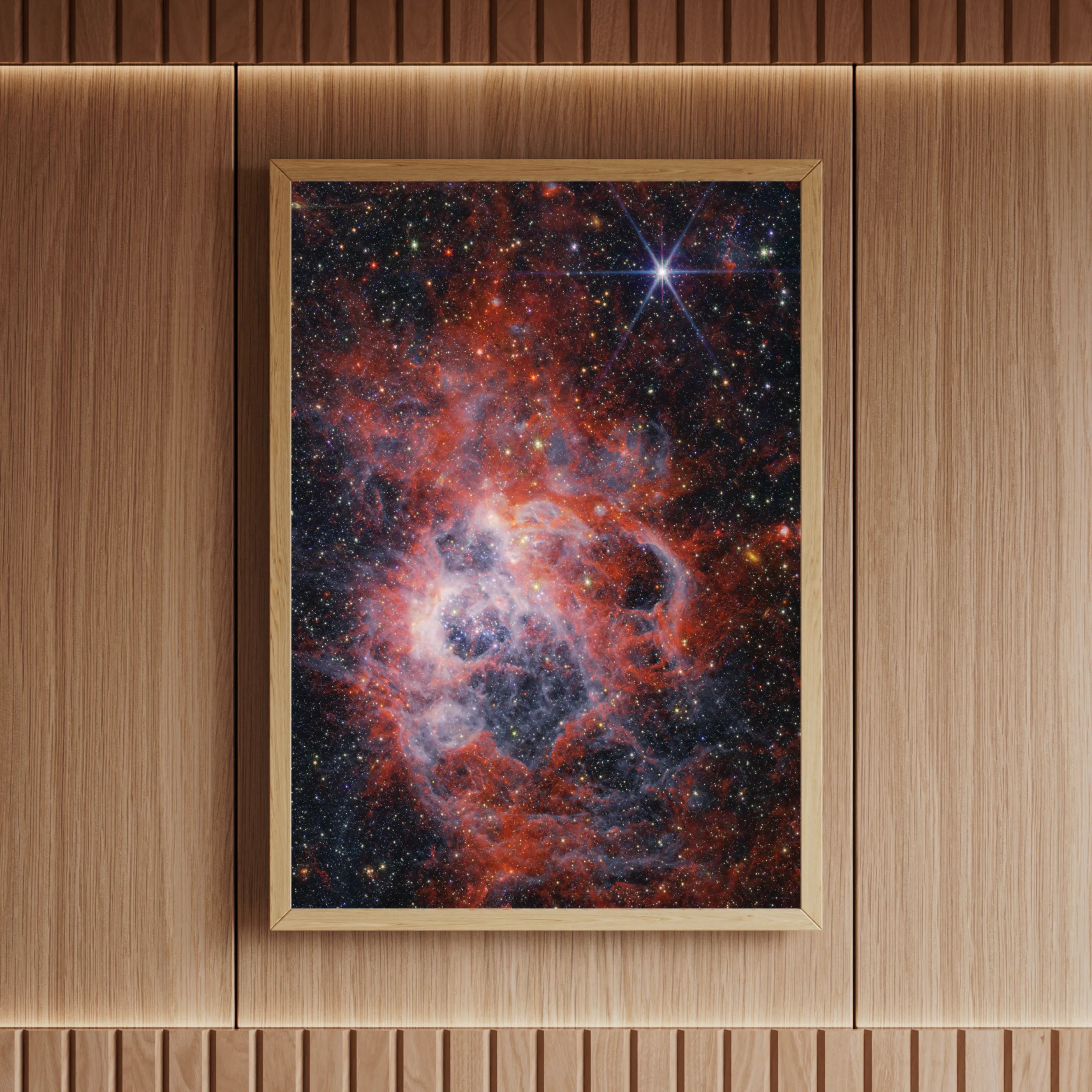 High-resolution nebula print of NGC 604 with vivid starfield and emission clouds, professionally framed and showcased in a modern wood-panelled space – from Skylit Studio’s astronomy print series.