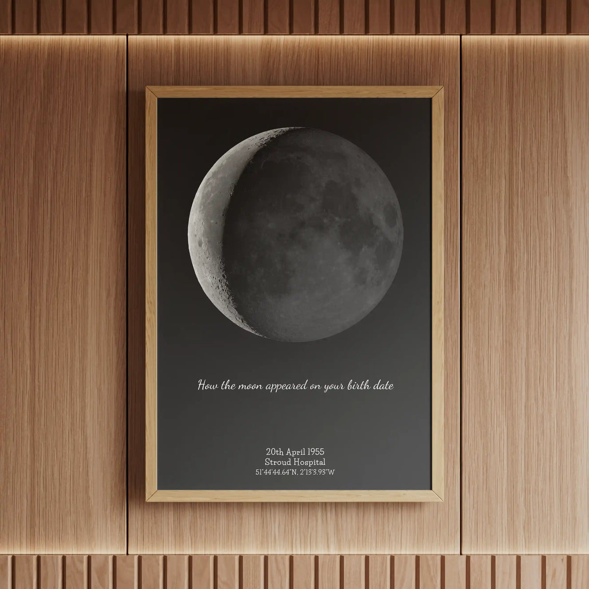 Framed personalised moon phase print showing how the moon appeared on a birth date, displayed in a wooden frame—unique celestial birth gift idea.