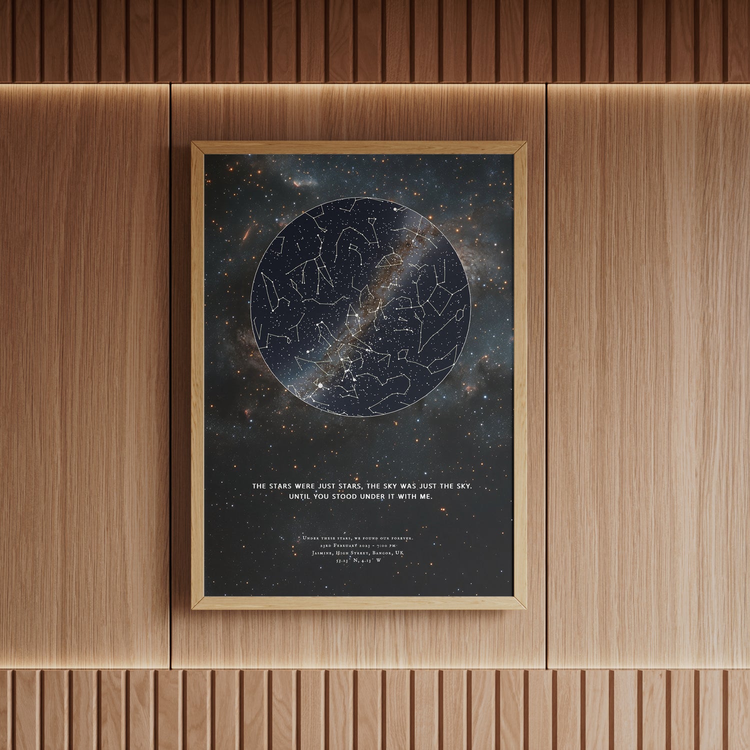 Personalized framed star map print in a natural wood brown frame, featuring a deep-space constellation design and the romantic quote &