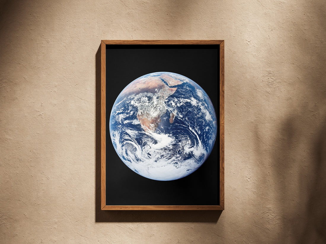 The Blue Marble print in a wooden frame on a plaster wall