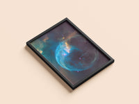 Bubble Nebula print in a black frame, flat lay