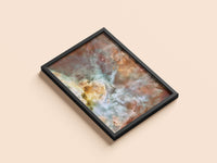 Carina Nebula print in a black frame, flat lay
