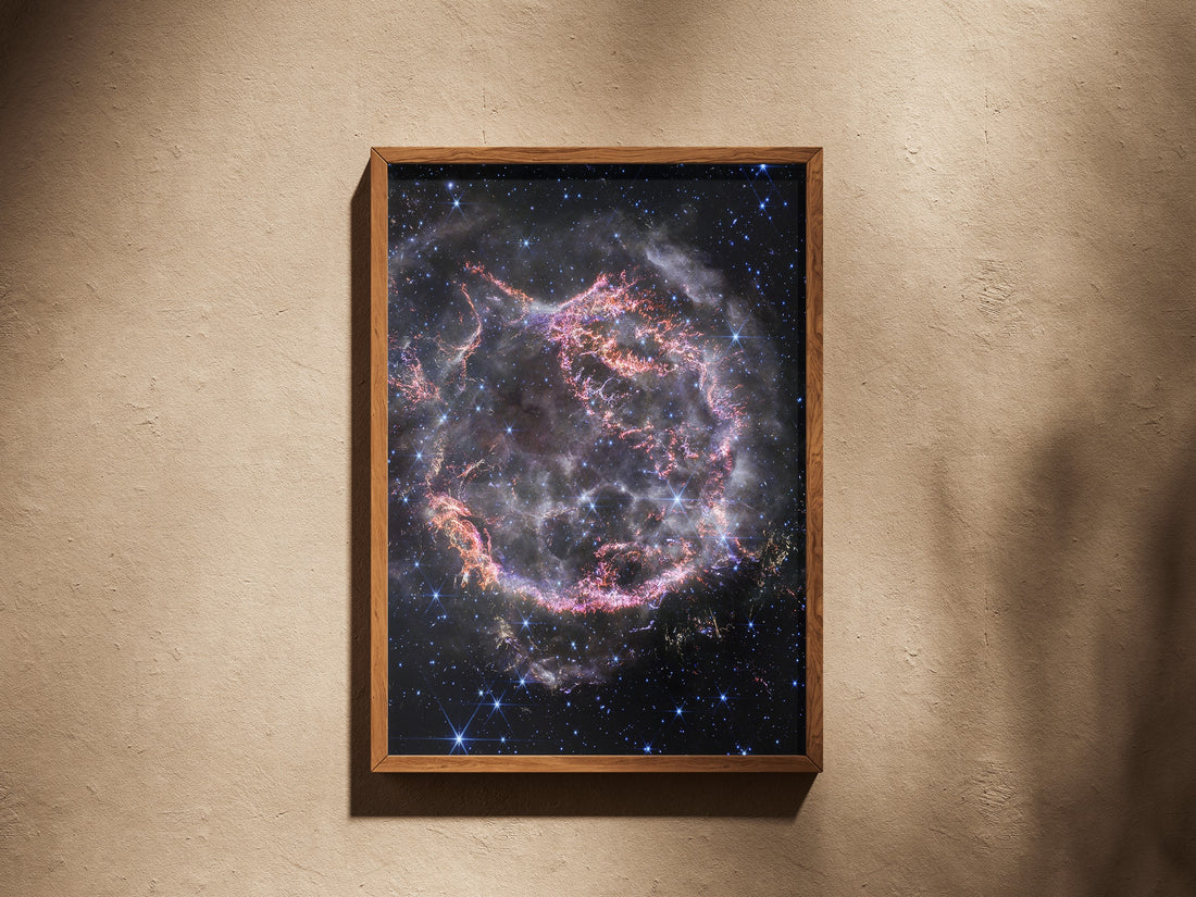 Cassiopeia A print in a wooden frame on a plaster wall