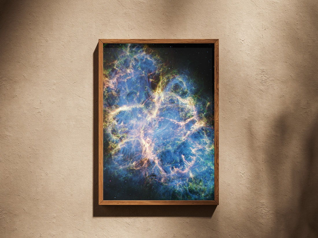 Crab Nebula print in a wooden frame on a plaster wall