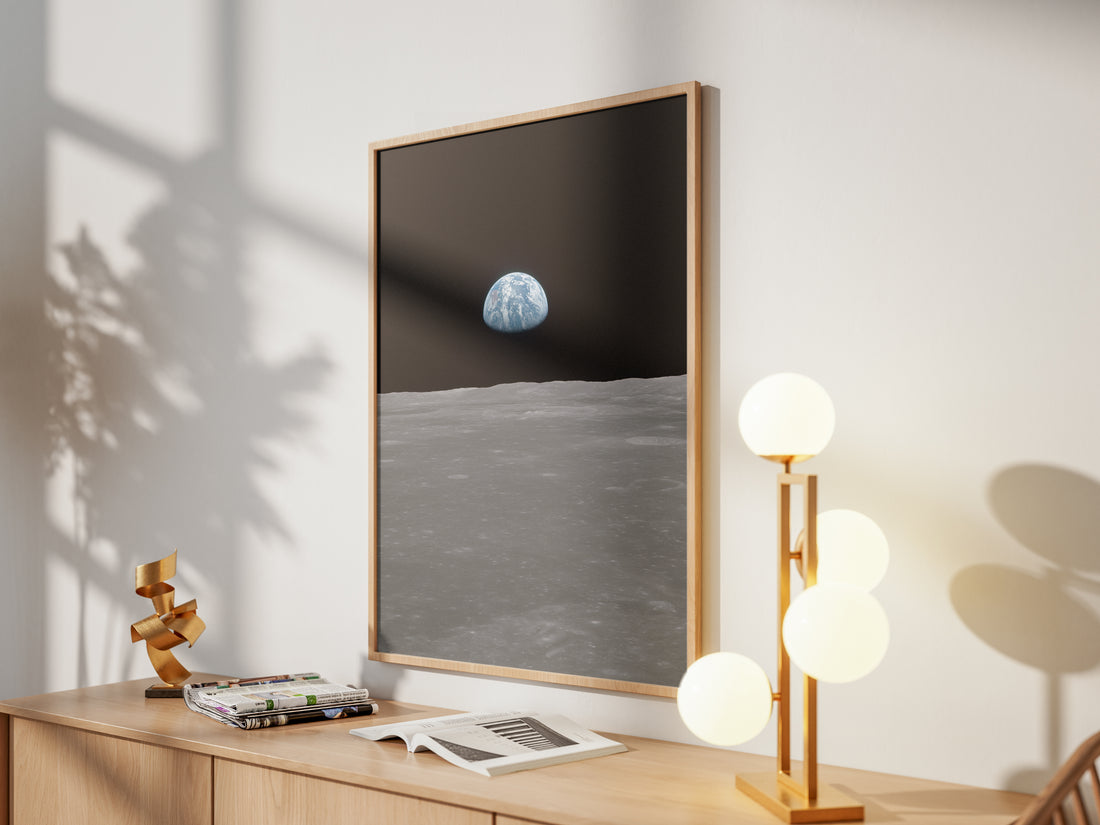 Framed Earth on the Horizon print by Skylit Studio on a sideboard in a bright living room