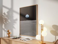 Framed Earth on the Horizon print by Skylit Studio on a sideboard in a bright living room