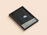Earthrise print in a black frame, flat lay
