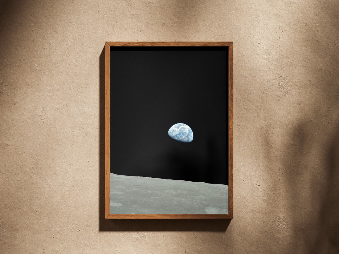 Earthrise print in a wooden frame on a plaster wall