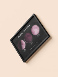 Pink moons family print in a black frame, flat lay