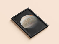 Jupiter print in a black frame, flat lay