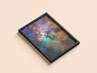 Lagoon Nebula print in a black frame, flat lay
