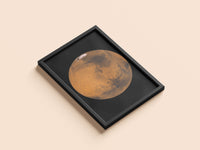 Mars print in a black frame, flat lay