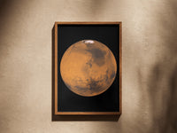 Mars print in a wooden frame on a plaster wall
