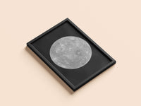 Mercury print in a black frame, flat lay
