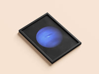 Neptune print in a black frame, flat lay