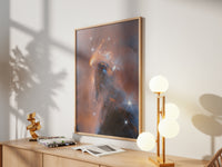Framed NGC 1333 Perseus print by Skylit Studio on a sideboard in a bright living room
