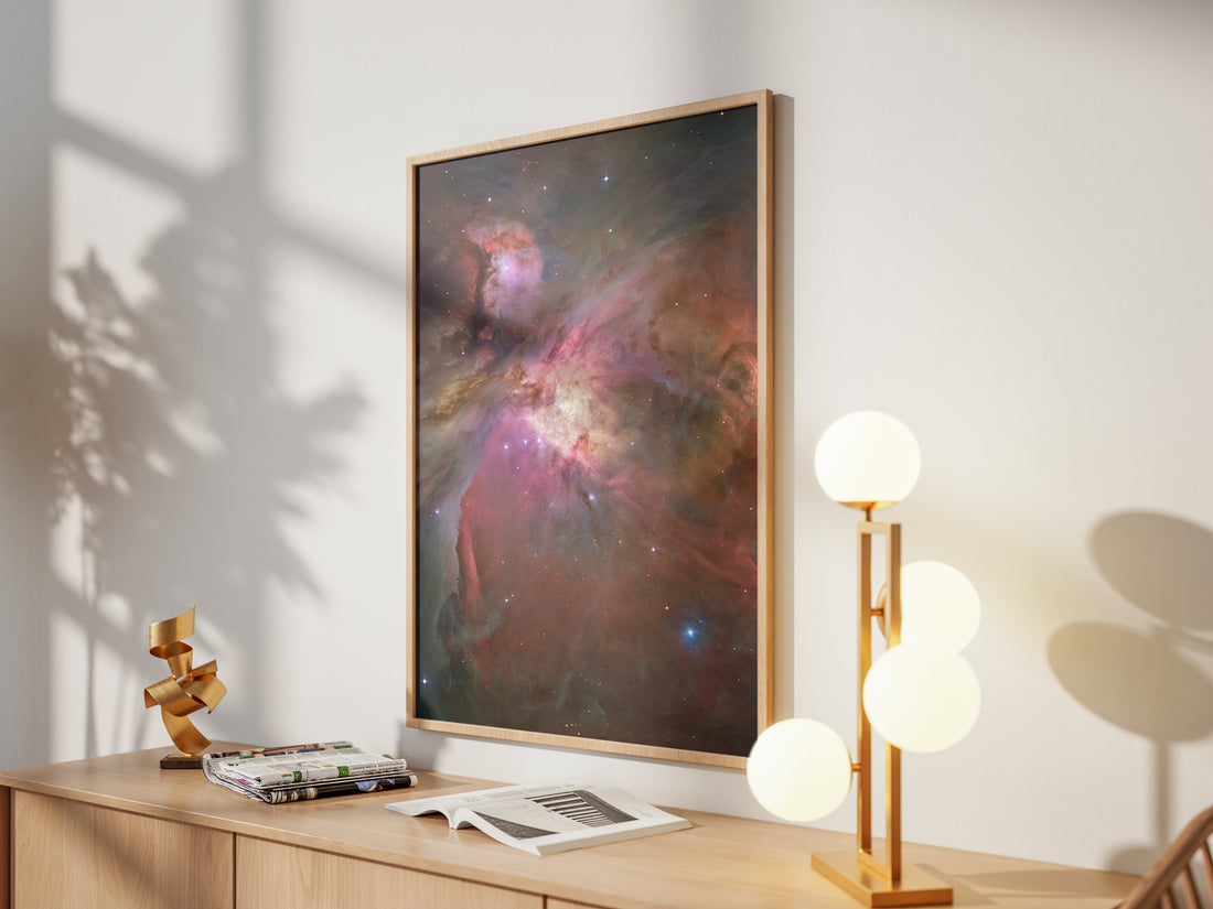 Framed Orion Nebula print by Skylit Studio on a sideboard in a bright living room