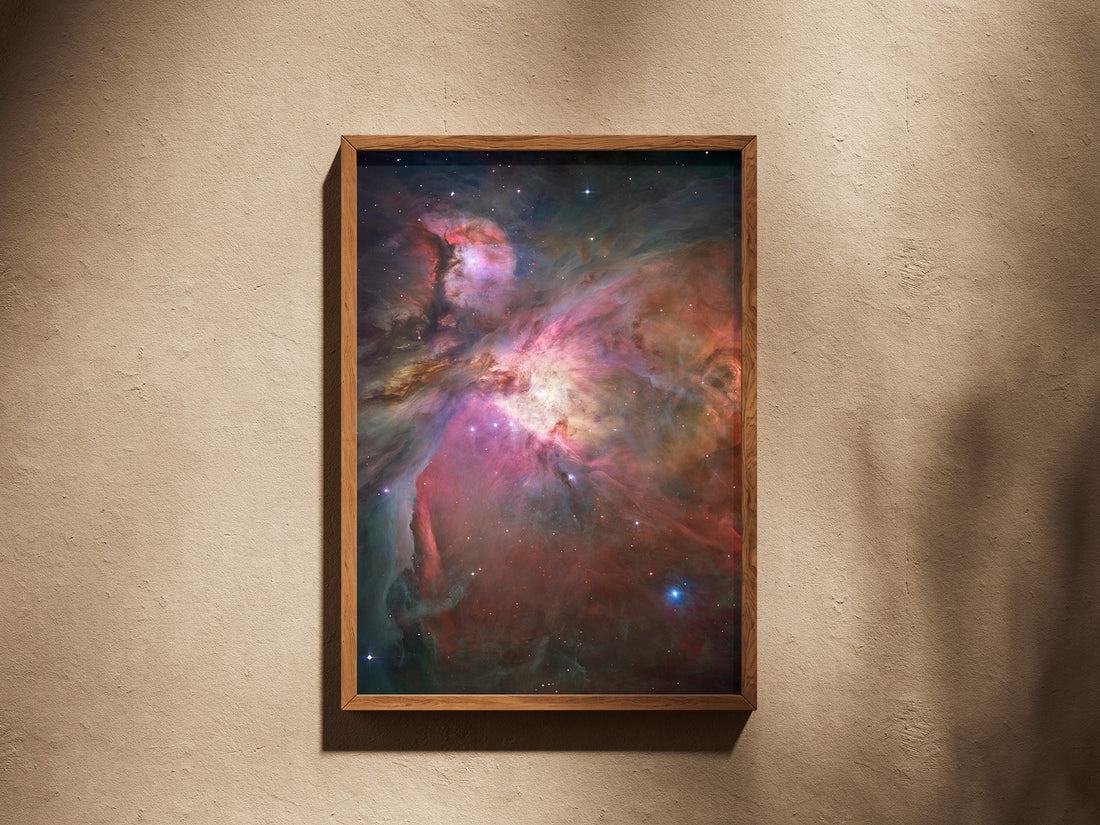 Orion Nebula print in a wooden frame on a plaster wall