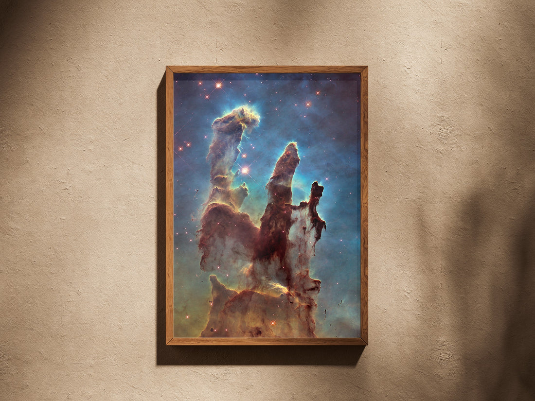 Pillars of Creation (Hubble) print in a wooden frame on a plaster wall