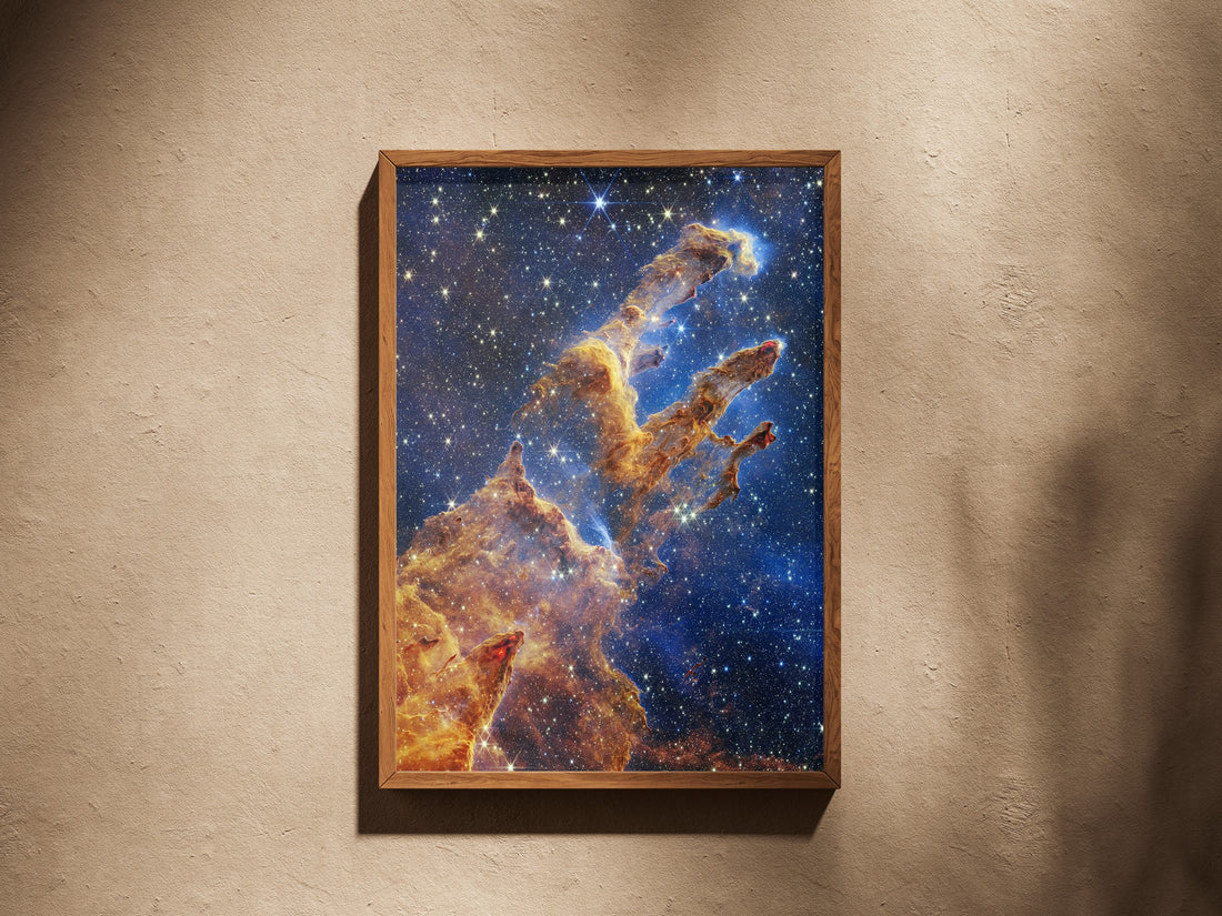 Pillars Of Creation print in a wooden frame on a plaster wall