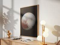 Framed Pluto print by Skylit Studio on a sideboard in a bright living room