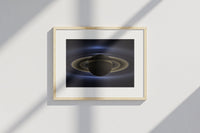 Framed Saturn print by Skylit Studio on a sideboard in a bright living room