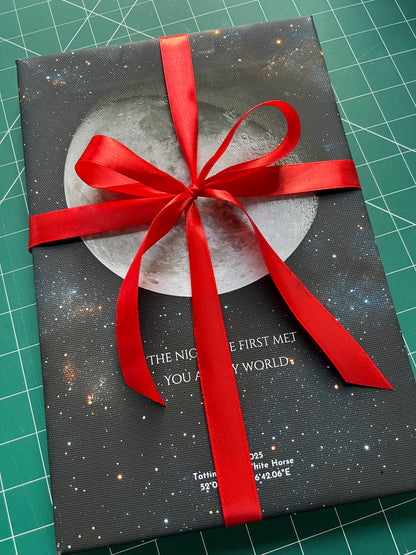 Gift-wrapped personalised moon phase print tied with a red ribbon, prepared as a ready-to-give keepsake.