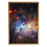 Framed deep space art print of the Serpens Nebula captured by the James Webb Space Telescope, featuring radiant stars and vibrant gas clouds in hues of blue, orange, and violet – part of Skylit Studio’s Deep Sky Collection.