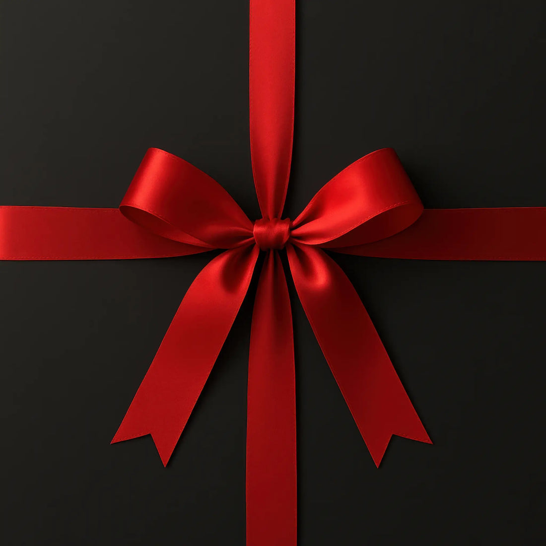 Luxurious red satin ribbon tied in a classic bow – perfect for showcasing premium gift wrapping at Skylit Studio.