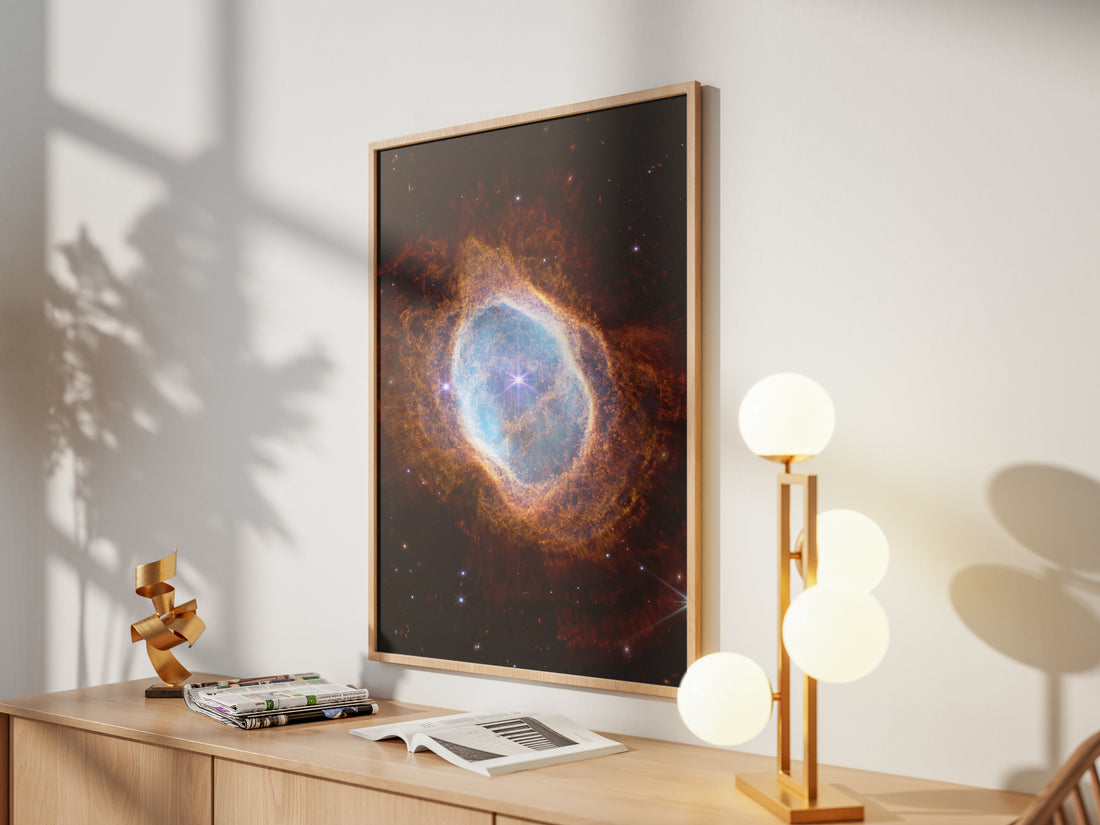Framed Southern Ring Nebula print by Skylit Studio on a sideboard in a bright living room