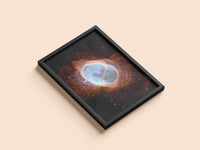 Southern Ring Nebula print in a black frame, flat lay