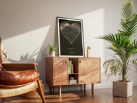 Heart-shaped star map in a black frame on a dresser