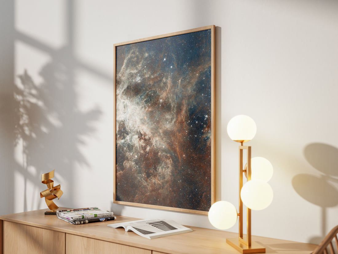 Framed Tarantula Nebula print by Skylit Studio on a sideboard in a bright living room