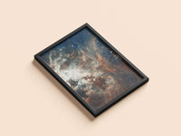 Tarantula Nebula print in a black frame, flat lay