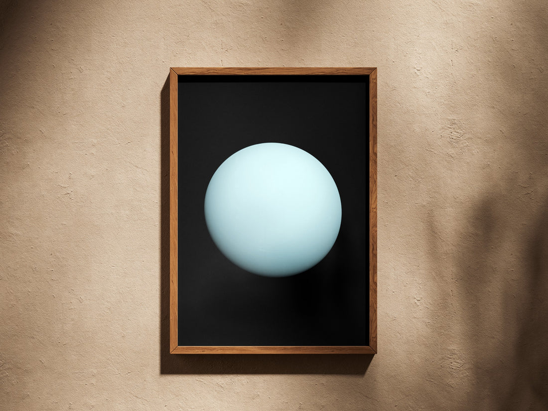 Uranus print in a wooden frame on a plaster wall