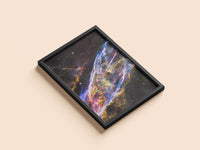 Veil Nebula print in a black frame, flat lay