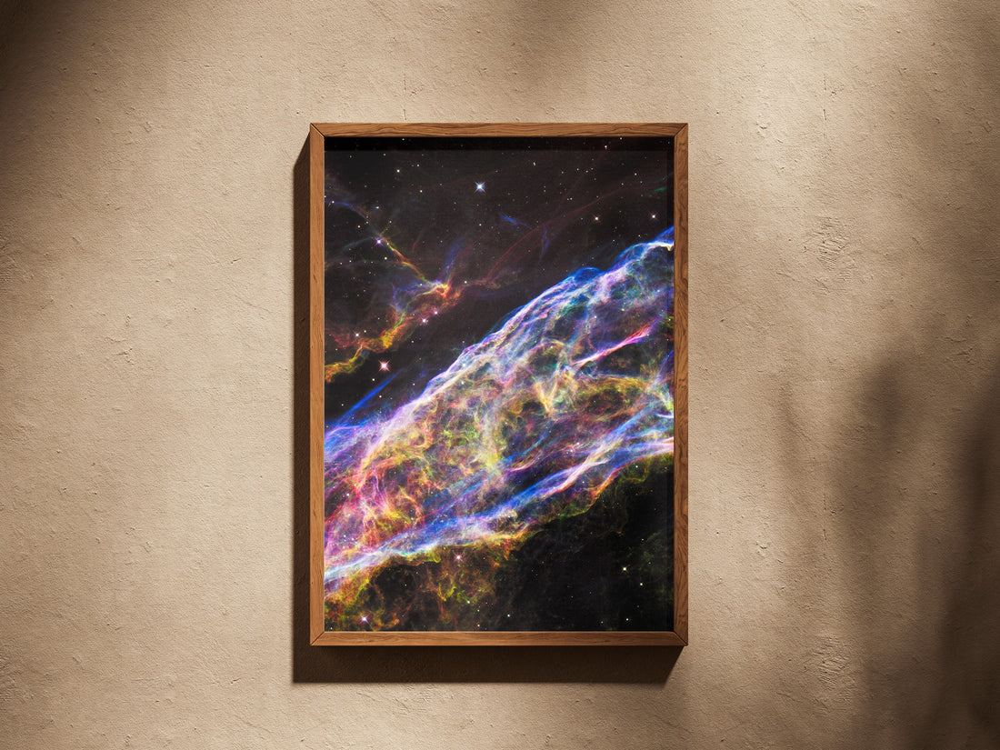 Veil Nebula print in a wooden frame on a plaster wall