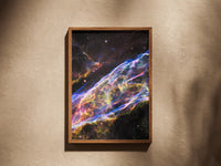 Veil Nebula print in a wooden frame on a plaster wall
